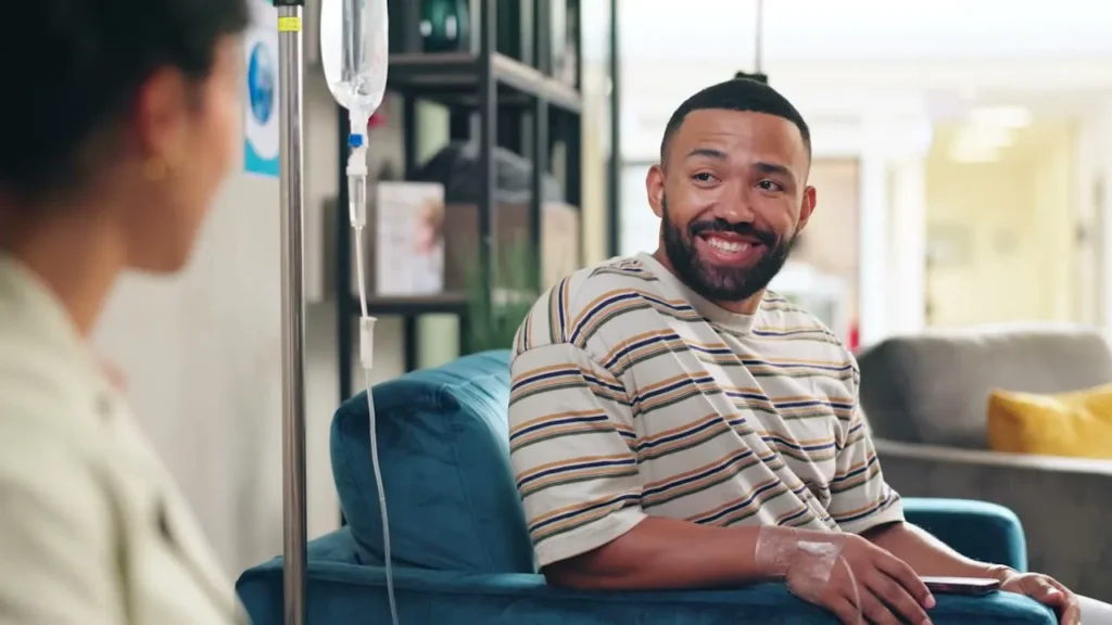 Man sitting in chair with an IV looking to his right