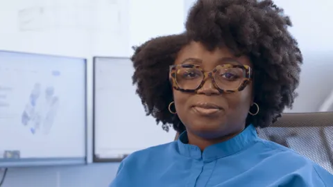 Woman with glasses looking at the camera